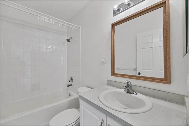 full bathroom featuring tiled shower / bath combo, vanity, and toilet