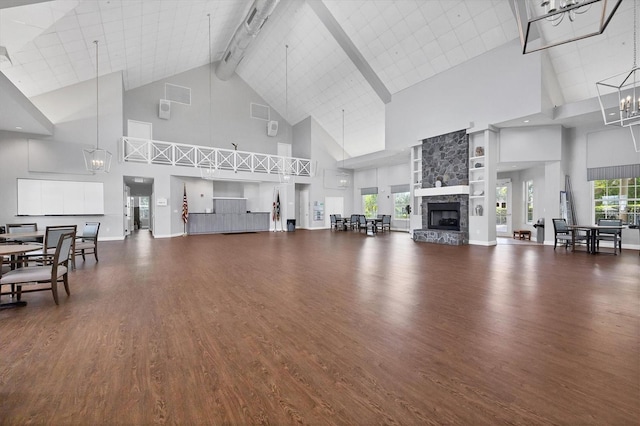 living room featuring high vaulted ceiling, a stone fireplace, beam ceiling, and dark hardwood / wood-style flooring