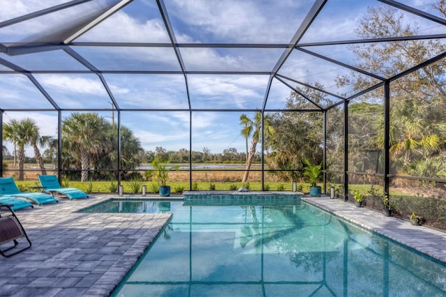 view of swimming pool featuring glass enclosure and a patio area