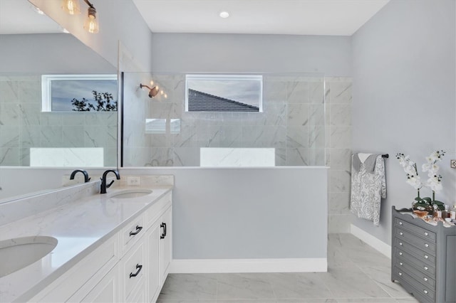 bathroom featuring vanity and tiled shower