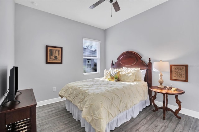 bedroom with ceiling fan and dark hardwood / wood-style floors