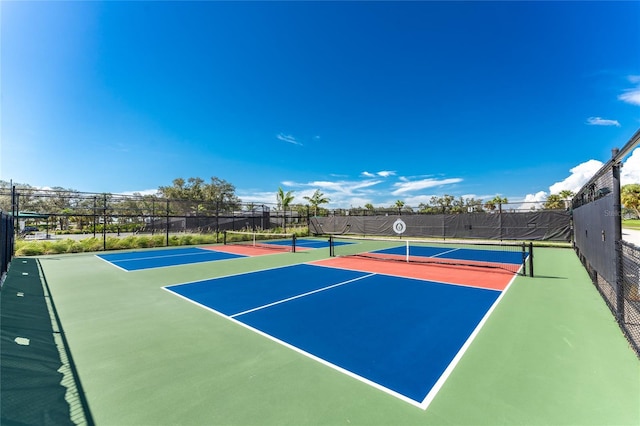 view of tennis court featuring basketball hoop