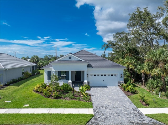 view of front facade with a front yard and a garage