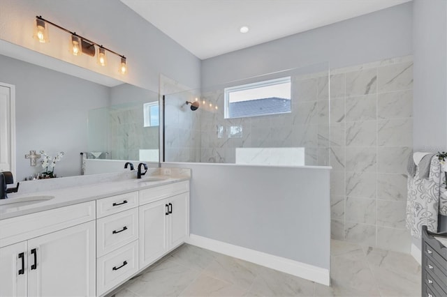 bathroom with vanity and tiled shower