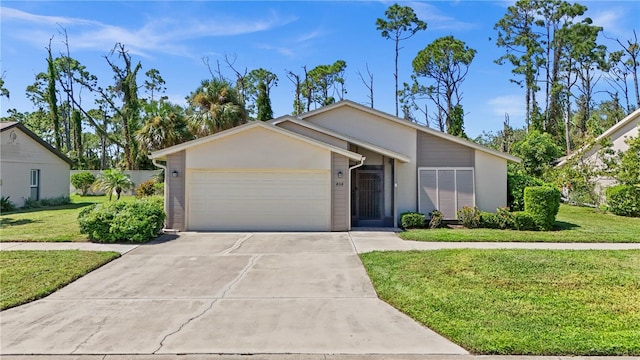 single story home featuring a front lawn and a garage