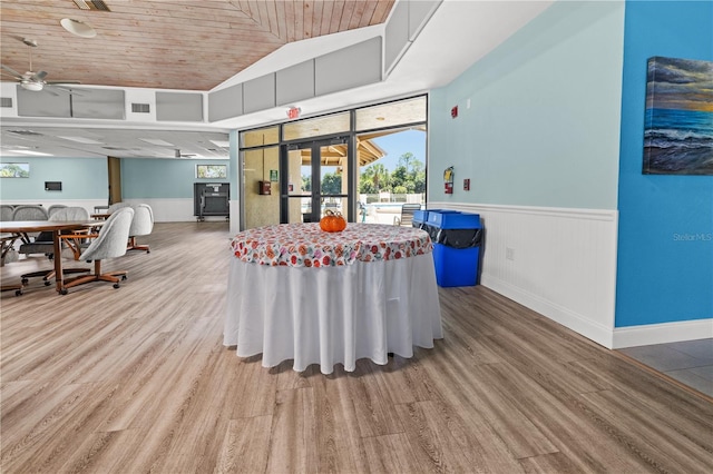 dining space featuring ceiling fan, french doors, wooden ceiling, wood-type flooring, and vaulted ceiling