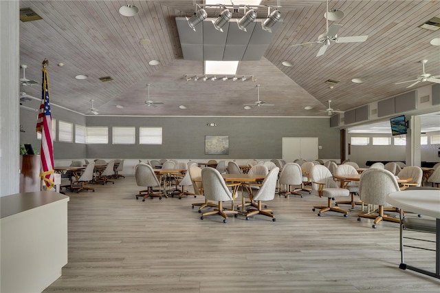 gym with light hardwood / wood-style floors, wood ceiling, and high vaulted ceiling