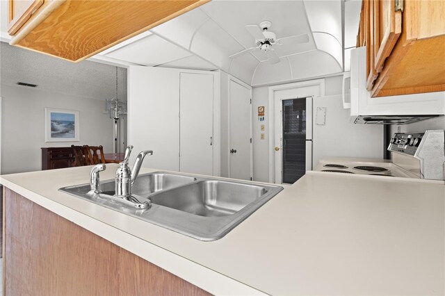 kitchen with white electric range oven, ceiling fan, and sink