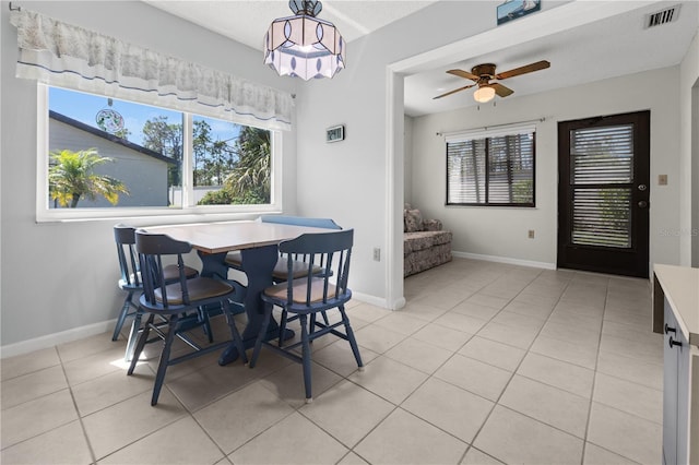 tiled dining area featuring ceiling fan