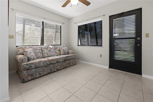 tiled living room featuring plenty of natural light and ceiling fan