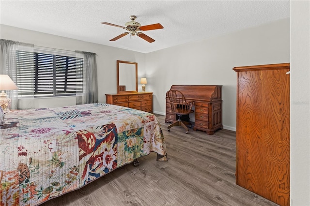 bedroom featuring wood-type flooring, a textured ceiling, and ceiling fan