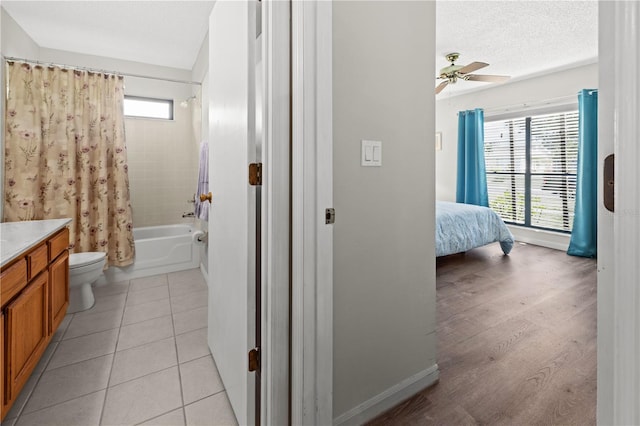 full bathroom featuring a wealth of natural light, vanity, shower / bath combo, and ceiling fan