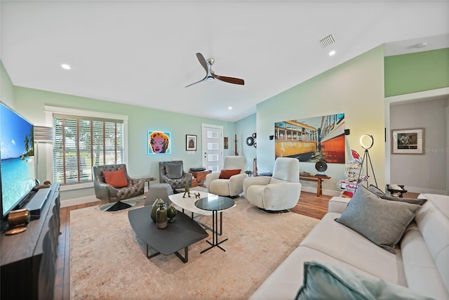 living room featuring ceiling fan and hardwood / wood-style floors