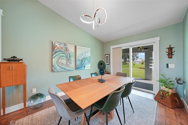 dining room with wood-type flooring and lofted ceiling