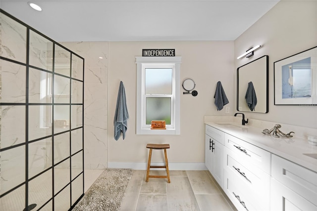 bathroom featuring hardwood / wood-style floors, vanity, and tiled shower