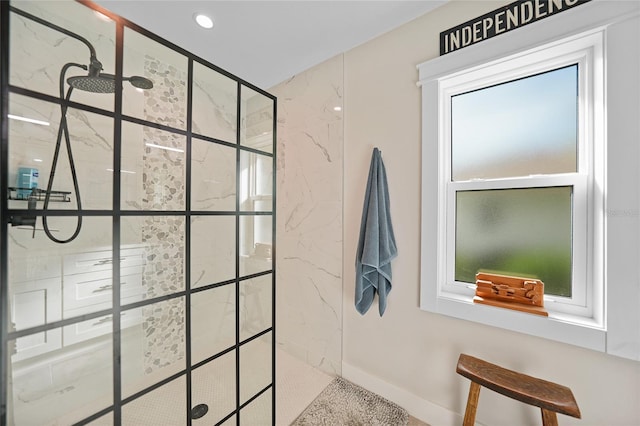 bathroom with plenty of natural light and tiled shower