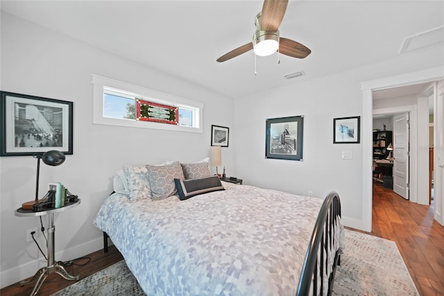 bedroom with ceiling fan and dark hardwood / wood-style flooring