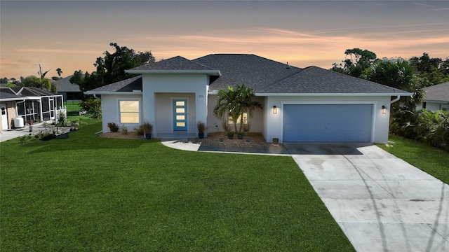 view of front of house with a garage and a lawn