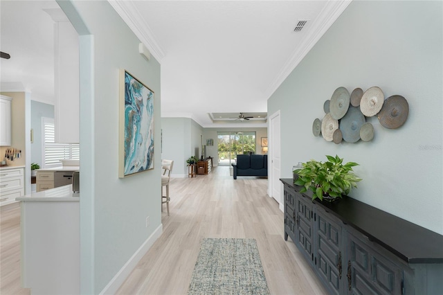 hallway with crown molding and light hardwood / wood-style flooring