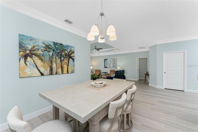 dining area with crown molding, light wood-type flooring, and ceiling fan with notable chandelier