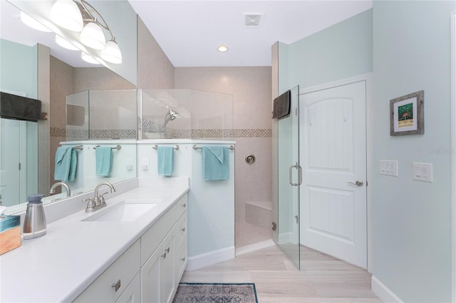 bathroom featuring vanity, hardwood / wood-style flooring, and an enclosed shower