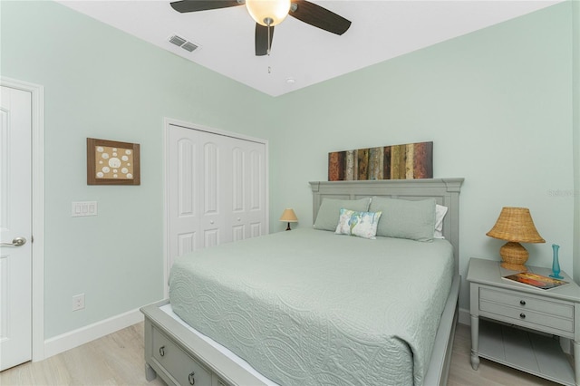 bedroom featuring light hardwood / wood-style floors, a closet, and ceiling fan