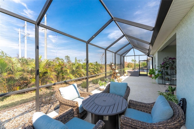 view of patio featuring an outdoor living space and glass enclosure