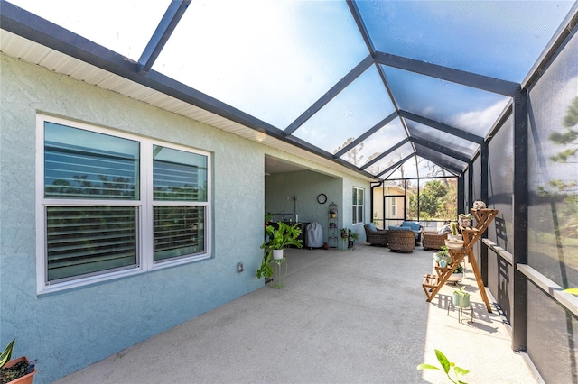 sunroom / solarium featuring vaulted ceiling with beams