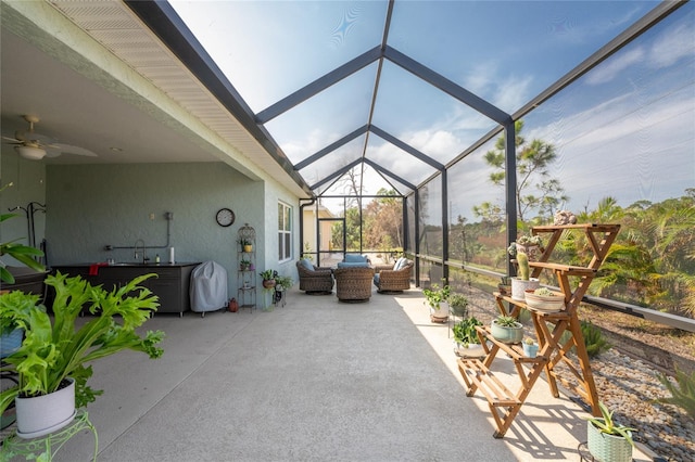 view of patio featuring an outdoor living space, glass enclosure, and ceiling fan