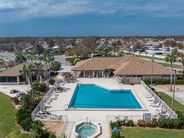 view of swimming pool with a patio area and a hot tub