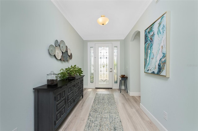 552 Box Elder Ct, Englewood, FL 34223 - entryway with light wood-style flooring, arched walkways, baseboards, and ornamental molding