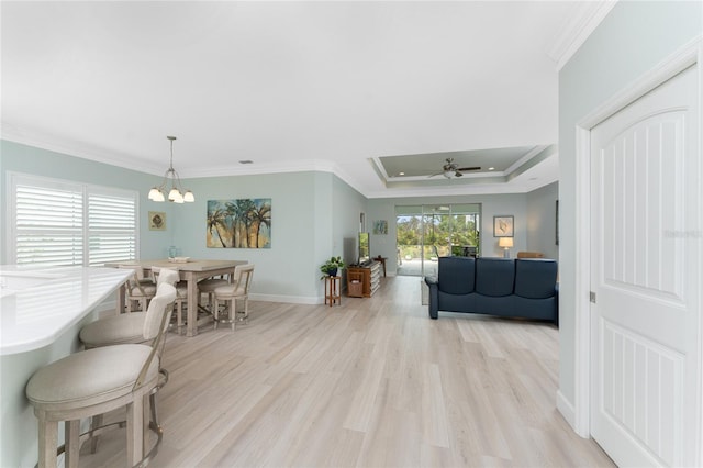 552 Box Elder Ct, Englewood, FL 34223 - living area with crown molding, baseboards, light wood-type flooring, and a raised ceiling