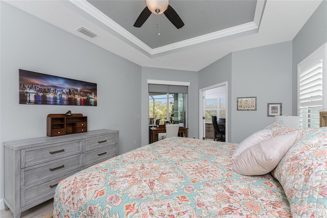 552 Box Elder Ct, Englewood, FL 34223 - bedroom featuring visible vents, a ceiling fan, a tray ceiling, and ornamental molding