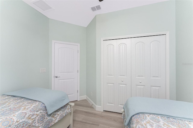 552 Box Elder Ct, Englewood, FL 34223 - bedroom with light wood-style floors, visible vents, a closet, and baseboards