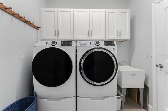 552 Box Elder Ct, Englewood, FL 34223 - laundry room featuring a sink, cabinet space, and washer and clothes dryer