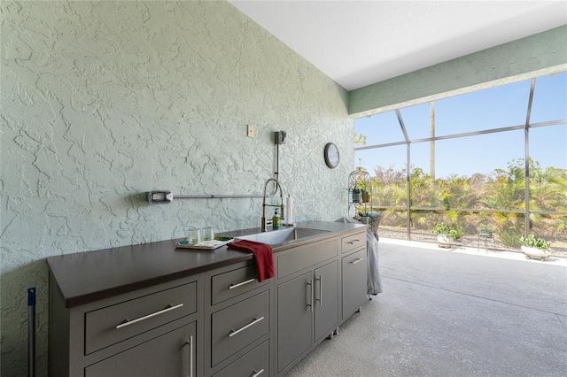 552 Box Elder Ct, Englewood, FL 34223 - exterior space with glass enclosure, an outdoor kitchen, and a sink