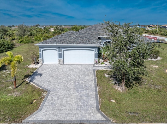 view of front facade with a garage and a front lawn