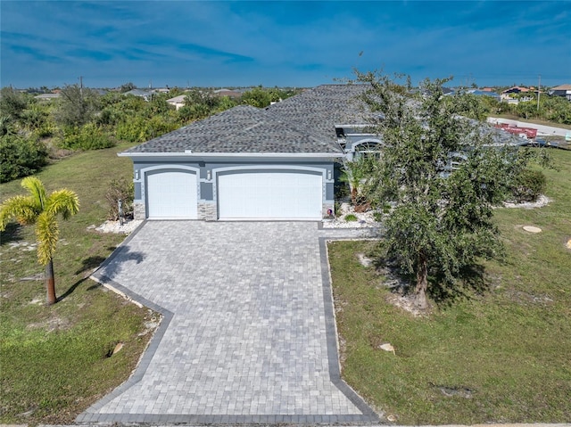14344 Amestoy Ave, Port Charlotte, FL 33981 - view of front of home with a garage, a front yard, stone siding, and decorative driveway