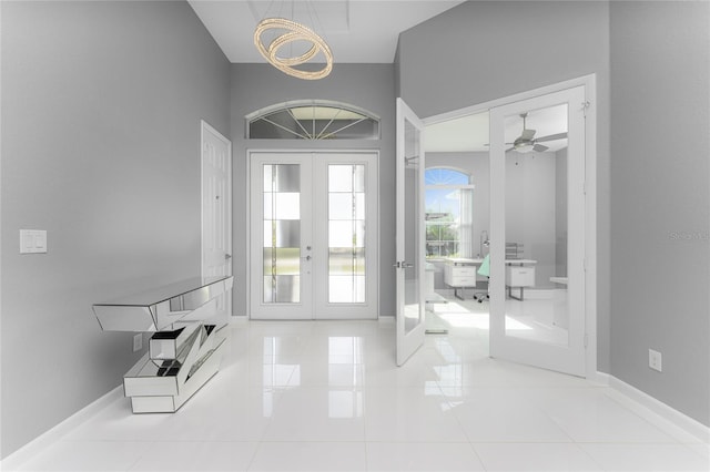 14344 Amestoy Ave, Port Charlotte, FL 33981 - tiled foyer with french doors, baseboards, and ceiling fan with notable chandelier