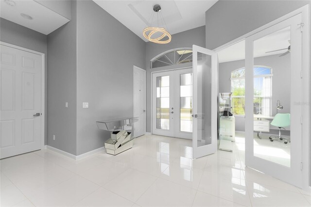 14344 Amestoy Ave, Port Charlotte, FL 33981 - foyer entrance featuring french doors, baseboards, a ceiling fan, and tile patterned flooring