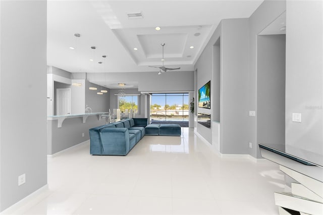 14344 Amestoy Ave, Port Charlotte, FL 33981 - tiled living room with a tray ceiling, ceiling fan, visible vents, and baseboards