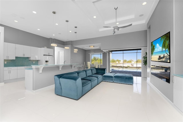 tiled living room featuring ceiling fan