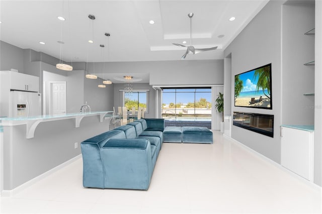 14344 Amestoy Ave, Port Charlotte, FL 33981 - living room featuring baseboards, recessed lighting, a tray ceiling, and a ceiling fan