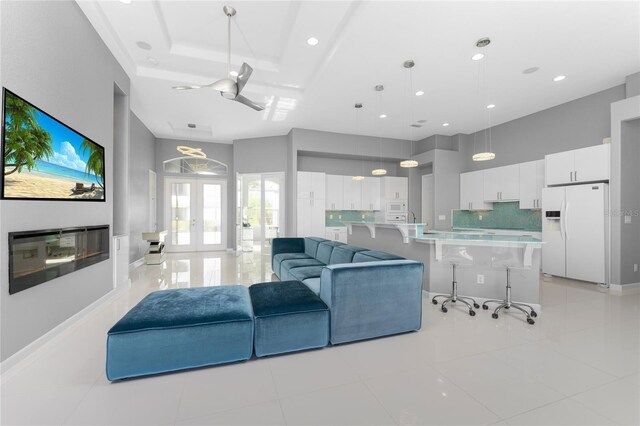 14344 Amestoy Ave, Port Charlotte, FL 33981 - living room with french doors, recessed lighting, a raised ceiling, and light tile patterned floors