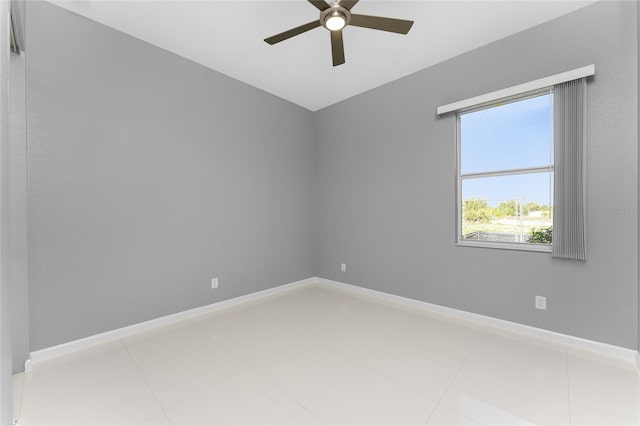 tiled empty room featuring ceiling fan