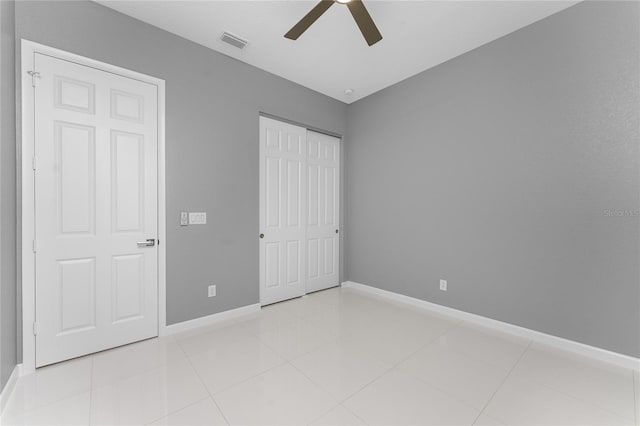 unfurnished bedroom featuring ceiling fan and light tile patterned flooring