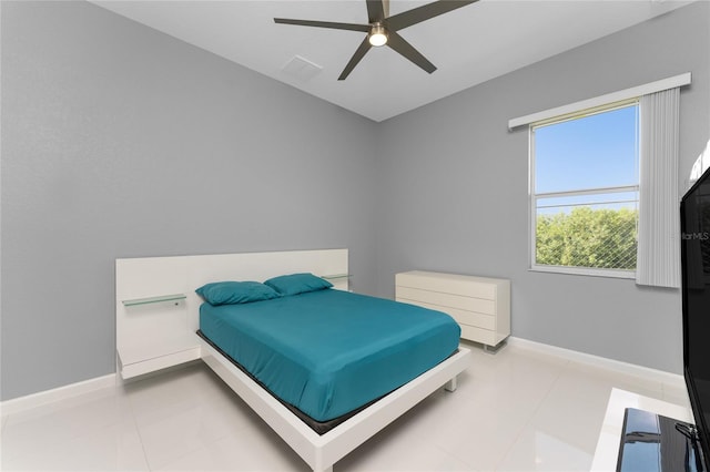 bedroom with ceiling fan and light tile patterned floors