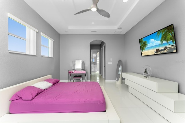 14344 Amestoy Ave, Port Charlotte, FL 33981 - bedroom with visible vents, a raised ceiling, arched walkways, ceiling fan, and tile patterned floors