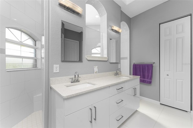 14344 Amestoy Ave, Port Charlotte, FL 33981 - full bath with a sink, tile patterned floors, double vanity, and a walk in shower