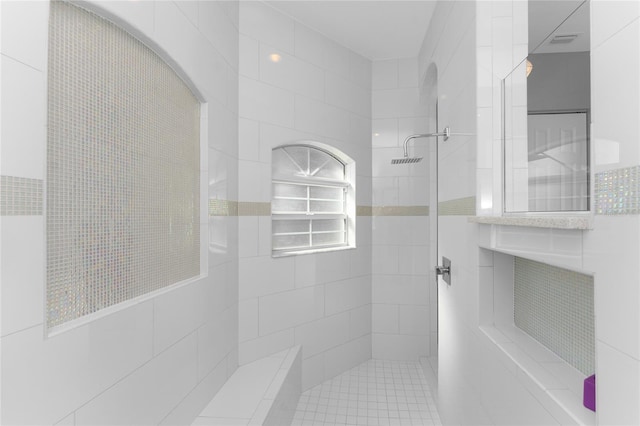 14344 Amestoy Ave, Port Charlotte, FL 33981 - bathroom featuring a tile shower, visible vents, and tile walls